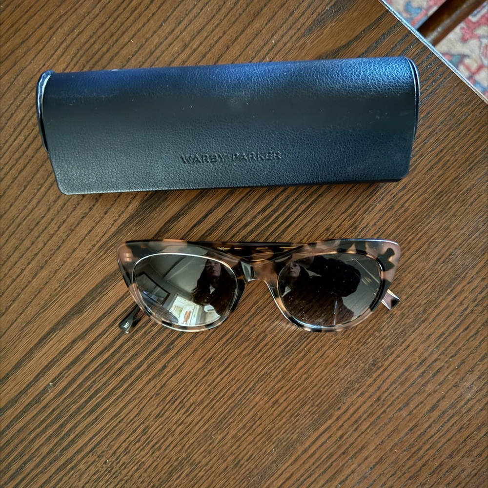 Warby Parker Tilley sunglasses in pink tortoise shell with dark lenses.